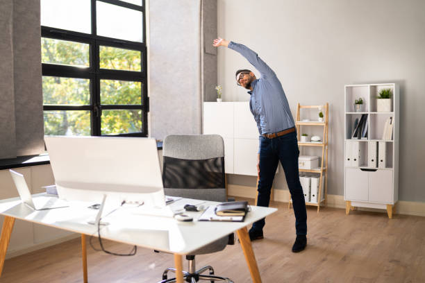 Person doing a subtle stretch in a modern office