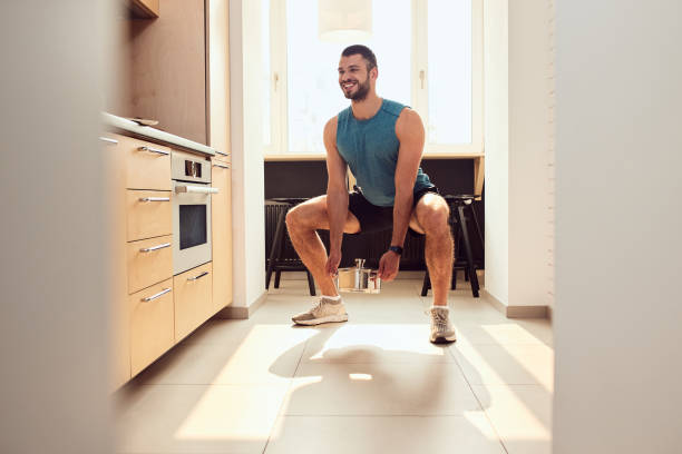 Person performing a quick squat in a home kitchen